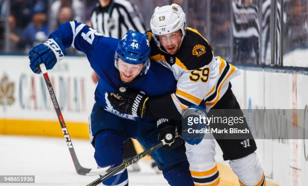 Morgan Rielly of the Toronto Maple Leafs battles with Tim Schaller of the Boston Bruins in Game Three of the Eastern Conference First Round during...