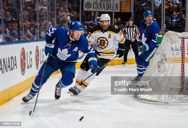 Morgan Rielly and Ron Hainsey of the Toronto Maple Leafs skate against Patrice Bergeron of the Boston Bruins in Game Three of the Eastern Conference...