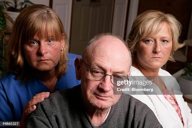 Colleen Hubley, left, her father-in-law LeRoy Hubley, and her sister-in-law Barbara Patton, right, pose at Patton's home in Toledo, Ohio, U.S., on...