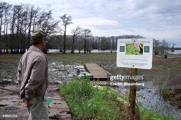 Ken Shaw, head of the Cypress Valley Navigation District, which oversees the boat lanes on Caddo Lake, surveys the buildup of giant salvinia and...