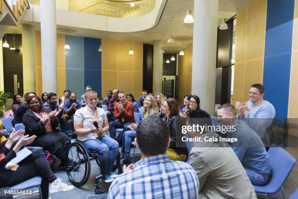 audience clapping for female speaker in wheelchair - surrounding support stock pictures, royalty-free photos & images