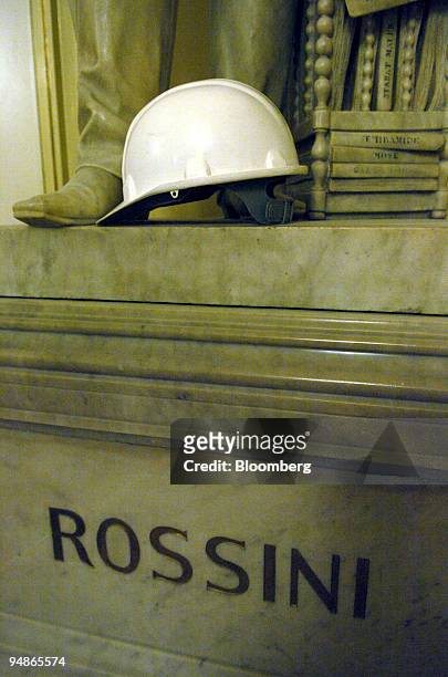 Workmans safety helmet seen on the plinth of a statue of Rossini at La Scala opera house in Milan, Italy, Friday, November 19, 2004. La Scala reopens...