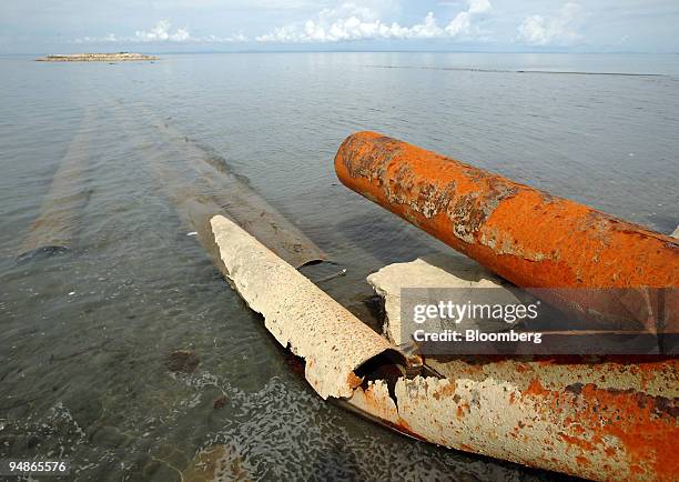 The abandoned, rusting remains of a tailings pipeline left over from the Marcopper Mining Corp. Operation lie on Calancan Beach October 11, 2005 on...