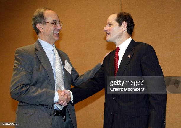 New York State Attorney General Eliot Spitzer, right, shakes hands with Kroll Inc. CEO Michael Cherkasky after Spitzer spoke at a seminar on mutual...
