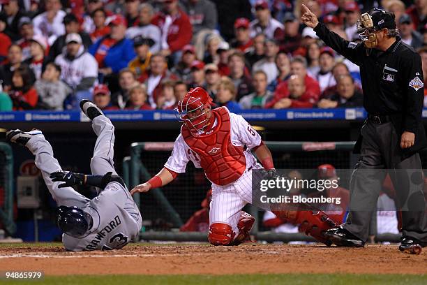 Carl Crawford of the Tampa Bay Rays, left, reacts in pain after being hit by a pitch by Joe Blanton of the Philadelphia Phillies in the sixth inning...