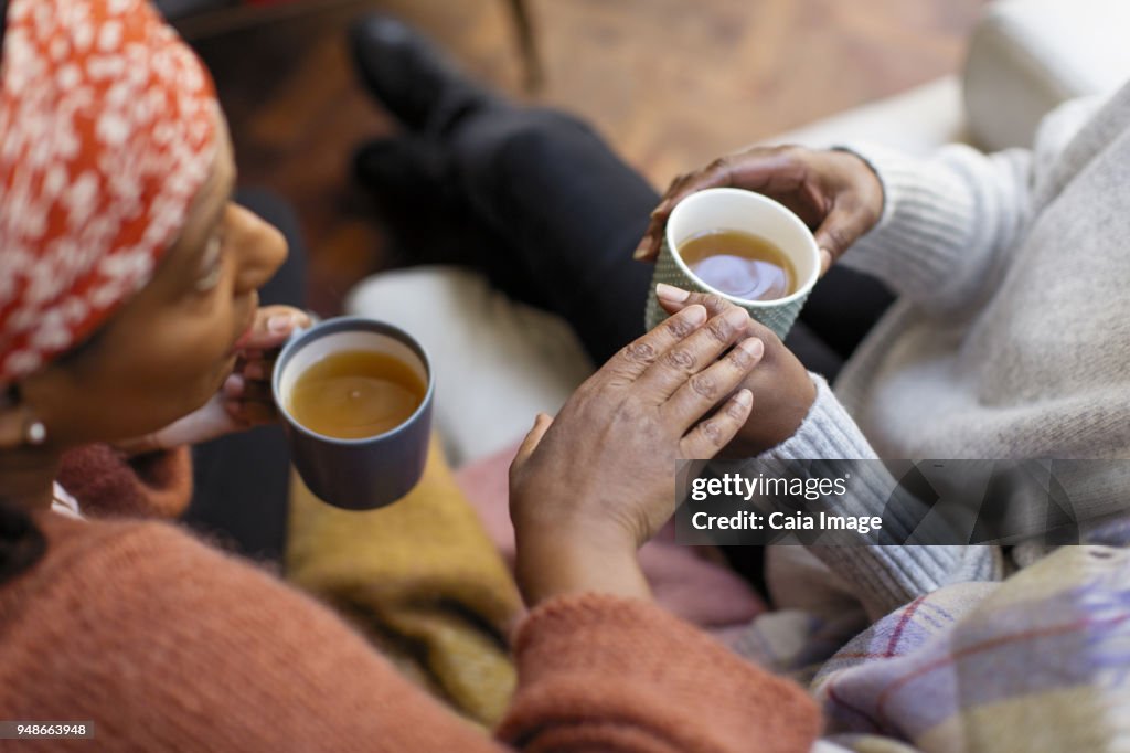 Women friends talking, drinking tea