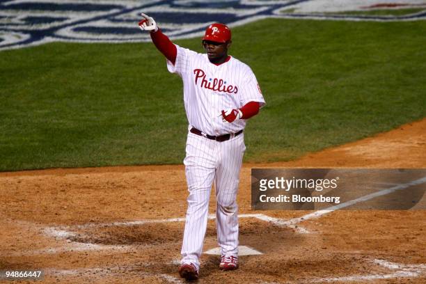 Ryan Howard of the Philadelphia Phillies gestures as he crosses home plate after hitting a solo home run off of Matt Garza of the Tampa Bay Rays in...