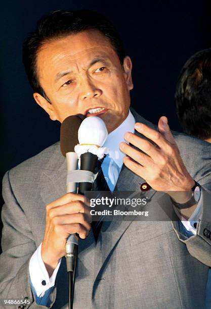 Taro Aso, Japan's prime minister, speaks on the top of a campaign van in the Akihabara district of Tokyo, Japan, on Sunday, Oct. 26, 2008. Aso may...