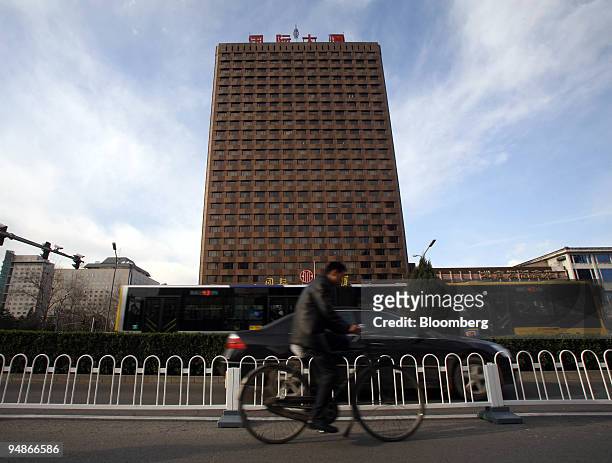 Bicyclist rides past the CITIC Tower on Chang An Street in Beijing, China, on Tuesday, March 25, 2008. Nicknaming public buildings is nothing new in...