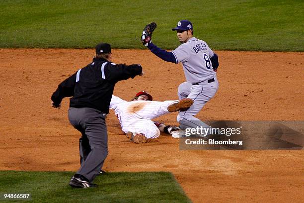 Jayson Werth of the Philadelphia Phillies, center, is out after being picked off of second base by Jason Bartlett of the Tampa Bay Rays in the eighth...