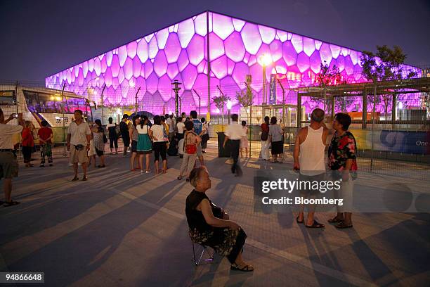Spectators take photos in front of the National Aquatics Center, or Water Cube, in Beijing, China, on Wednesday, Aug. 6, 2008. The 3.5 hour opening...
