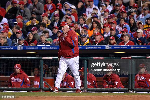 Charlie Manuel, manager of the Philadelphia Phillies, walks to the mound to make a pitching change in the seventh inning of game three of the Major...