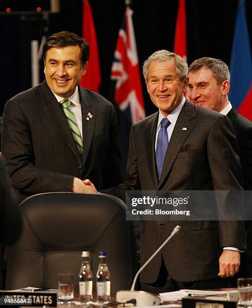 Mikheil Saakashvili, Georgia's president, left, shakes hands with U.S. President George W. Bush, during the NATO summit in Bucharest, Romania, on...