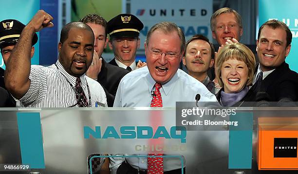 Glenn Tilton, United Airlines president and chief executive officer, center, reacts as he pushes a remote ringing the Nasdaq Opening Bell for trading...