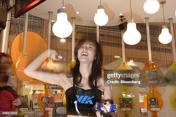 Model throws gifts to a crowd gathered at the VIA display area at the 2005 Computex Information and Technology Show which opened in Taipei, Taiwan,...