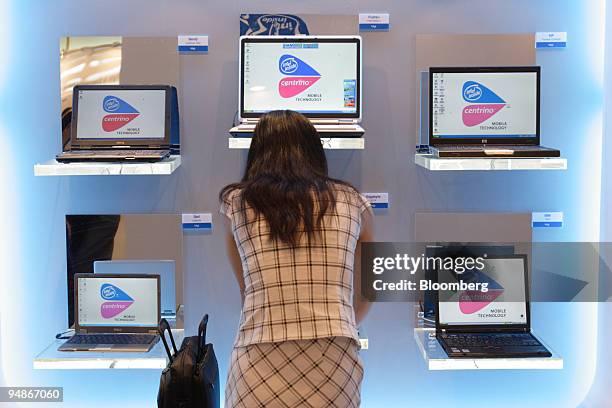 Woman works with a laptop computer on display in the Intel showroom at the 2005 Computex Information and Technology Show which opened in Taipei,...