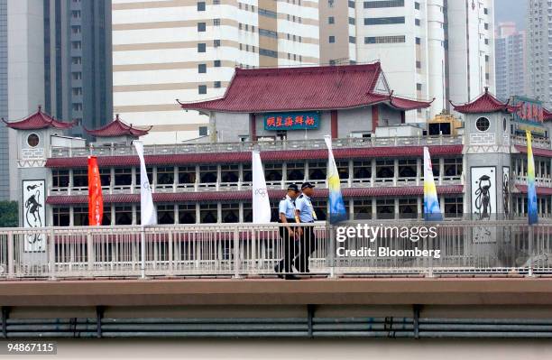 Two policemen patrol a bridge near the Olympic Equestrian venue in the Sha Tin area of Hong Kong, China, on Tuesday, Aug. 5, 2008. Hong Kong will...