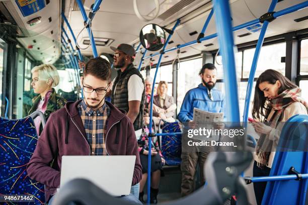 freelancer working on laptop in public bus - commuter bus stock pictures, royalty-free photos & images