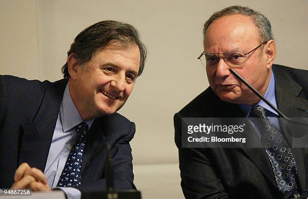 Jean-Rene Fourtou, left, chief executive officer of Vivendi Universal SA, talks to Jacques Espinasse, the company's chief financial officer, during a...