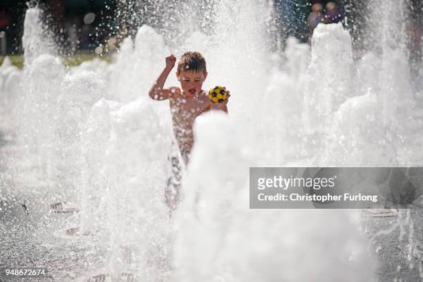 Young boy cools off in the fountains in Piccadilly Gardens on April 19, 2018 in Manchester, United Kingdom. Weather forecasters have recorded the...