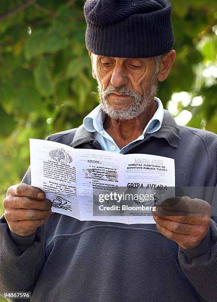 An elderly resident of Tulcea, Romania, reads a health warning notice about the dangers of bird flu on Tuesday, October 11, 2005. Romanian officials...