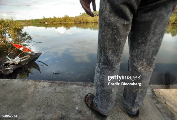 Filipino man looks at the Boac River October 10, 2005 on Marinduque Island in the Philippines. Though rehabilitated in the recent years, the river is...