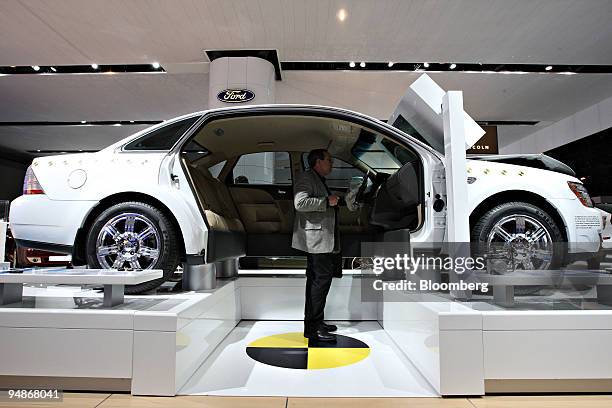 Steven Ashley watches a video inside a 2008 Ford Taurus which underwent crash safety testing on display during a media preview of the 2008 New York...