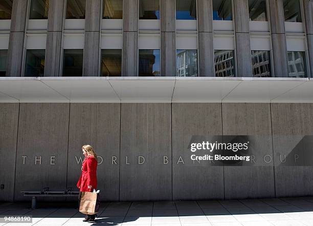 Woman walks past the World Bank headquarters in Washington, D.C., U.S., on Wednesday, April 2, 2008. The World Bank and International Monetary Fund...