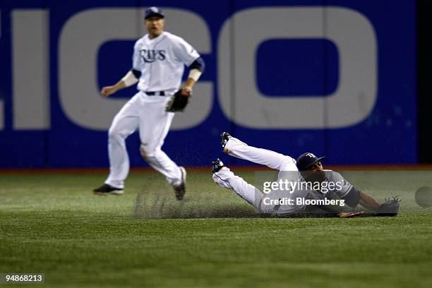 Upton of the Tampa Bay Rays dives for the ball in center field but catches it on one hop on a hit by Greg Dobbs of the Philadelphia Phillies in the...