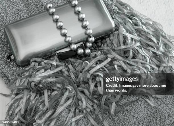 pearl neck lace, detail of a shawl and  a siver clutch. still life. - black tie party fancy stock pictures, royalty-free photos & images