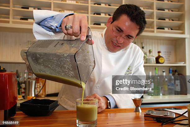 Mixologist Junior Merino pours a cocktail at Macondo in the Lower East Side neighborhood of New York, U.S., on July 30, 2008. Merino doesn't call...