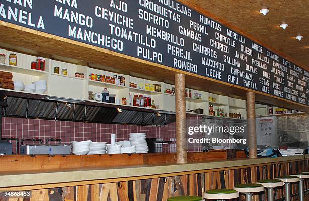 Menu items are displayed above the counter at Macondo in the Lower East Side neighborhood of New York, U.S., on July 30, 2008. Merino doesn't call...