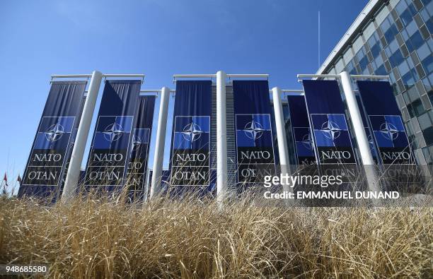 Banners with the NATO logo are pictured in front of the new NATO headquarters during a press tour of the facilities as the organization is moving...