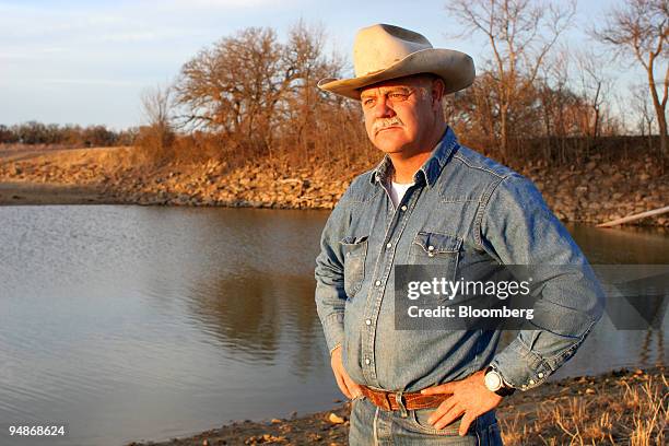 Brite stands near a pond that is dangerously low due to drought at the JA Ranch in Bowie, Texas on Tuesday, January 31, 2006. Though the JA Ranch is...
