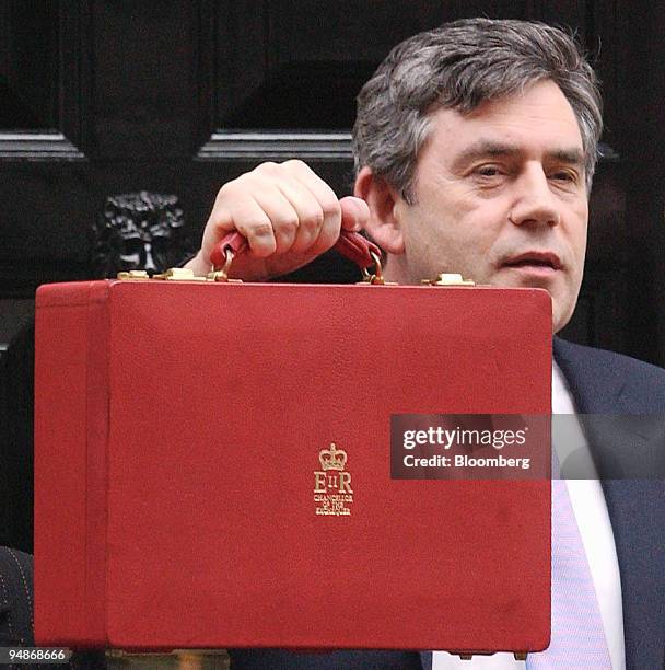 Chancellor Gordon Brown hold his red box up outside number 11 Downing Street in London, England, before delivering the contained 2004 budget in the...