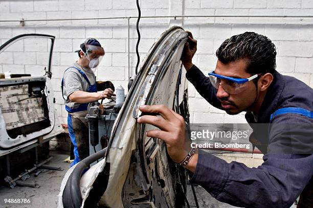 Workers prepare door panels for armor in the AutoSafe factory of Wendler Blindajes Alemanes in Mexico City, Mexico on Friday, Feb. 22, 2008. WBA,...