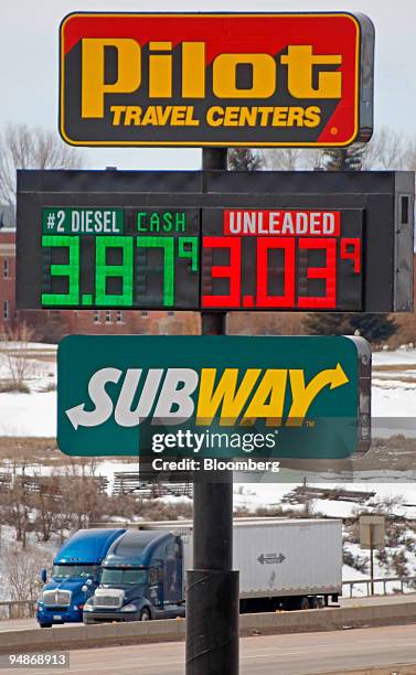 Trucks make their way east bound on Interstate-80 as a sign advertises diesel and gas prices in Evenston, Wyoming, U.S., on Tuesday, April 1, 2008....