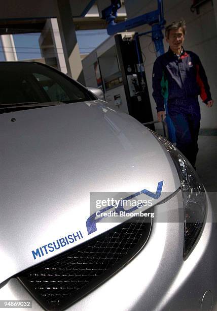 Mitsubishi Motors Fuel Cell Vehicle stops at a hydrogen dispenser before going on a test run at the Japan Hydrogen and Fuel Cell Development...