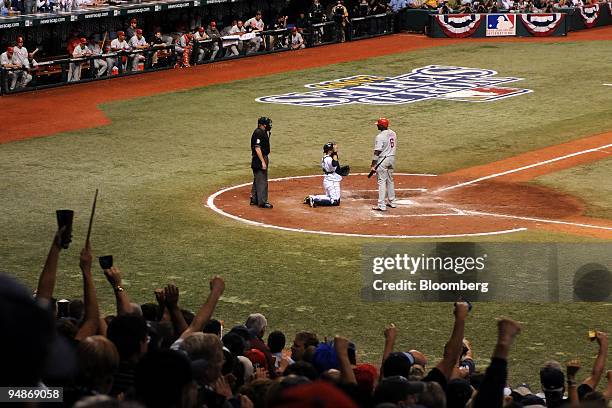 Ryan Howard of the Philadelphia Phillies, right, reacts after being called out on strikes against Trever Miller of the Tampa Bay Rays in the ninth...