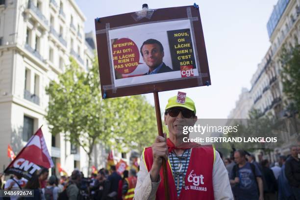 Protester holds a placard depicting French President Emmanuel Macron reading "But I said: I won't let anything go !! Not you !! - We will not let...