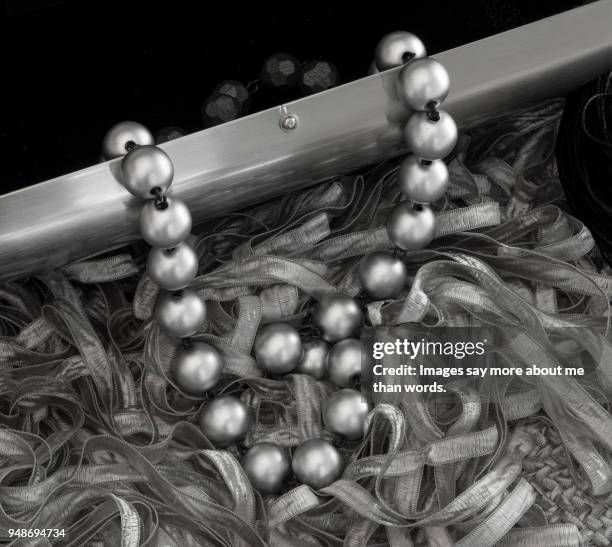 close up of pearls escaping from a clutch. - black tie party fancy stock pictures, royalty-free photos & images