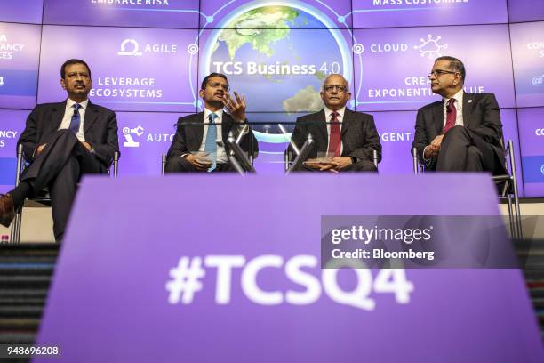 Rajesh Gopinathan, chief executive officer and managing director of Tata Consultancy Services Ltd., second left, speaks, as Ajoy Mukherjee, executive...