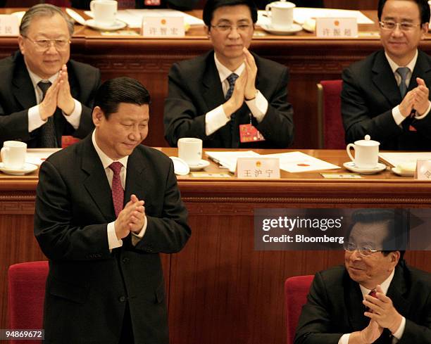 Xi Jinping, China's newly appointed vice president, left, looks to Zeng Qinghong, China's outgoing vice president, as members of China's congress...