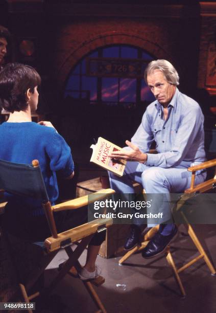 American VJ Martha Quinn interviews British record producer and composer George Martin at MTV Studios, New York, New York, October 3, 1983. Martin...