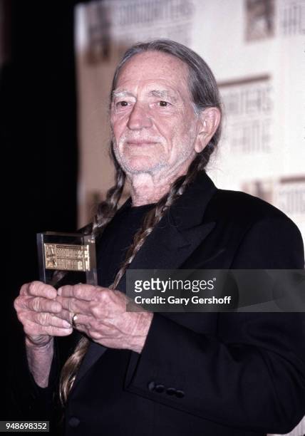 Portrait of American Country musician Willie Nelson as he attends the Songwriters Hall of Fame Awards Dinner at the New York Sheraton Hotel, New...