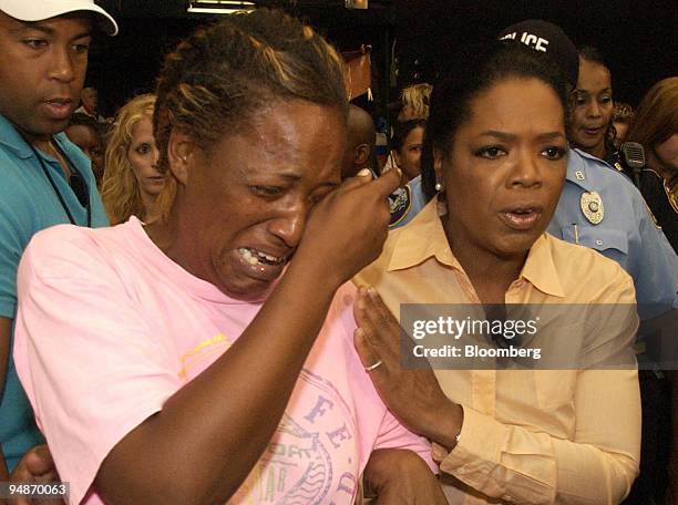Hurricane Katrina survivor Mary Lee Quinn, left, cries as she talks to TV personality Oprah Winfrey about her search for missing relatives as Oprah...