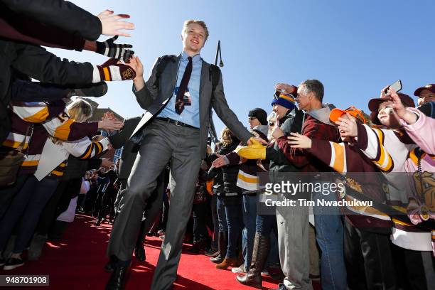 Riley Tufte of the Minnesota-Duluth Bulldogs shakes hands with fans prior to the Division I Men's Ice Hockey Championship held at on April 7, 2018 in...