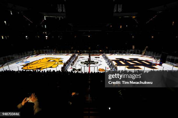 The Notre Dame Fighting Irish and the University of Minnesota Duluth Bulldogs stand at attention during the Division I Men's Ice Hockey Championship...