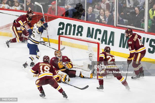 Andrew Oglevie of the Notre Dame Fighting Irish reacts after scoring against the Minnesota-Duluth Bulldogs during the Division I Men's Ice Hockey...