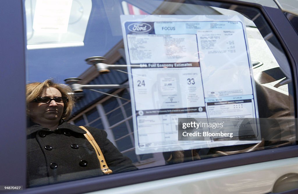 Jennifer Masse is reflected in the window of a new Ford Focu